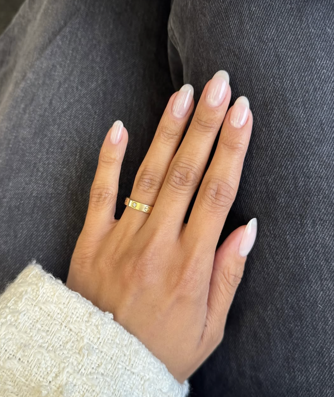 Long almond shaped nails with a sheer milky white "soap nail" polish and a high-gloss finish.