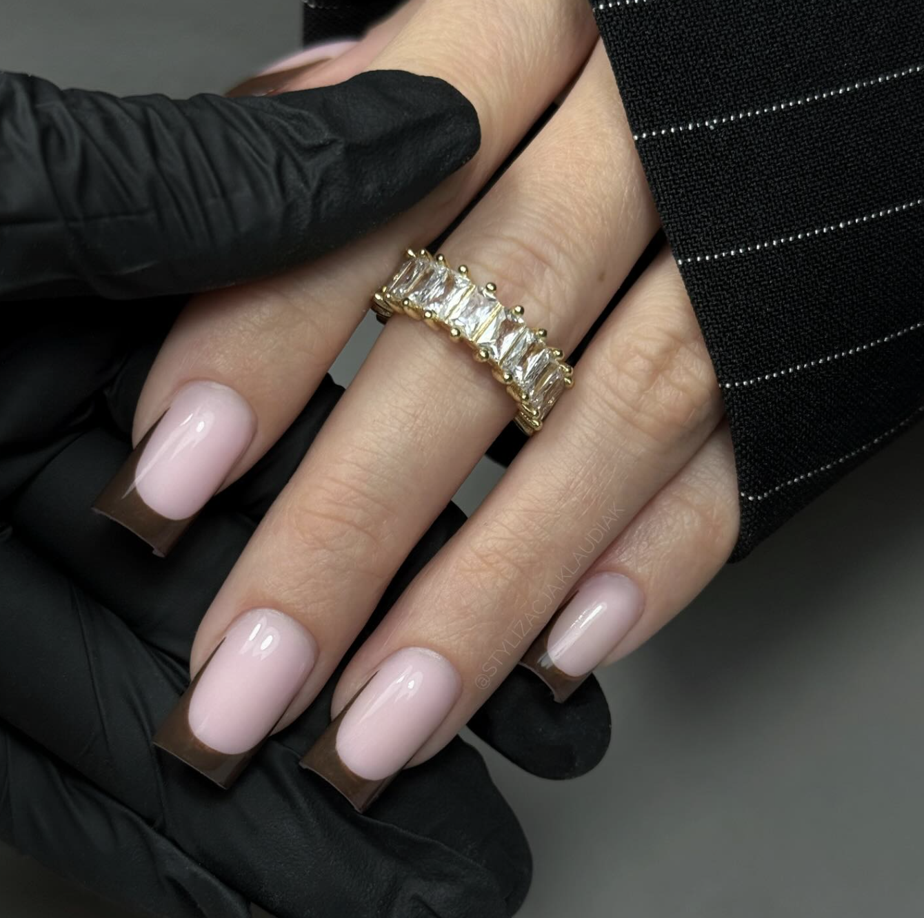Square-shaped nails with a sheer pinkish-nude base and a rich, chocolate brown French tip.