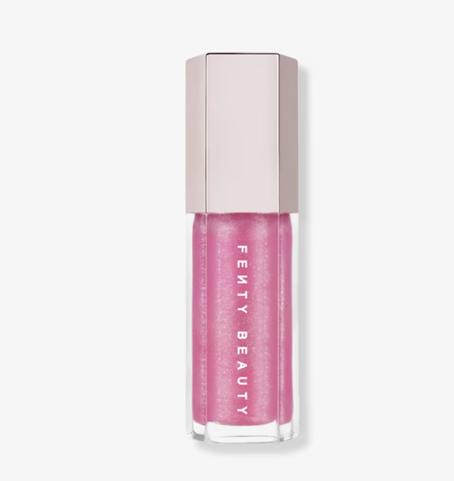 Fenty Beauty Gloss Bomb Universal Lip Luminizer in a clear hexagonal tube with a rose-gold cap, showing the shimmering pink gloss formula.