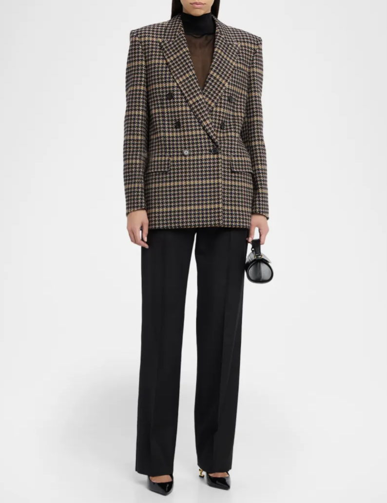 A high-end double-breasted Saint Laurent Check Blazer in a brown houndstooth pattern, styled with a black turtleneck and black trousers for a powerful, expensive look.