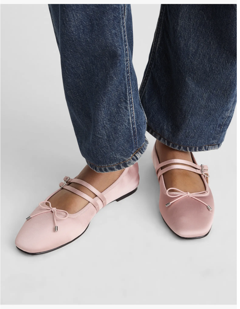 A pair of Madewell Greta Double Strap Ballet Flats in a soft petal pink leather with two thin adjustable straps.