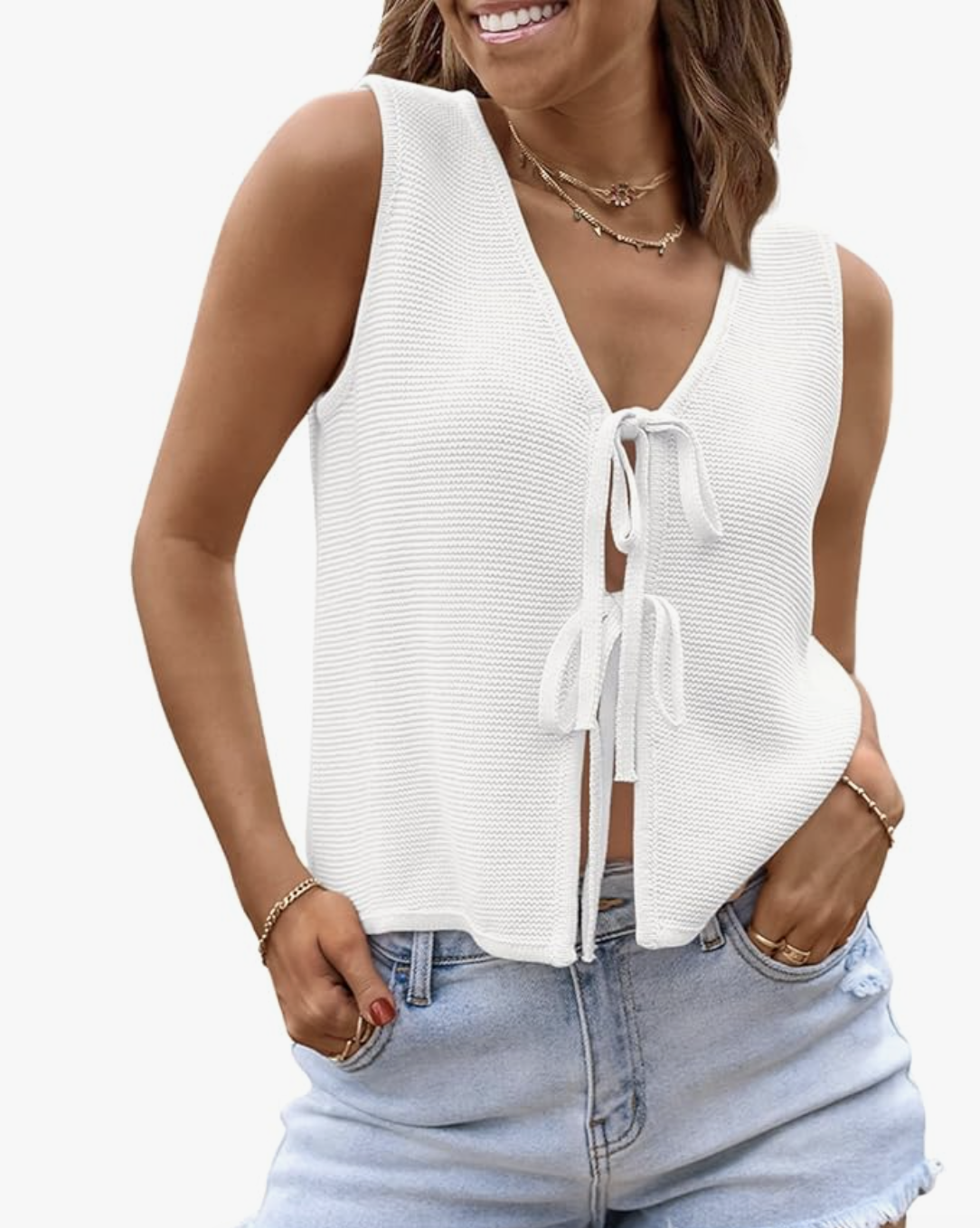 A woman wearing a white crochet tie-front tank top with light-wash denim, styled as a comfortable daytime outfit for what to wear on a cruise.