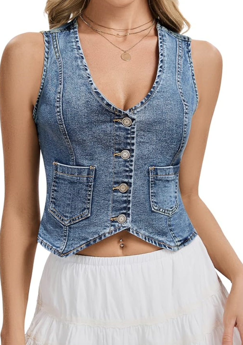 Close-up front view of a woman wearing a fitted, light-wash denim vest with button closures and structured seam details, styled over a white top.