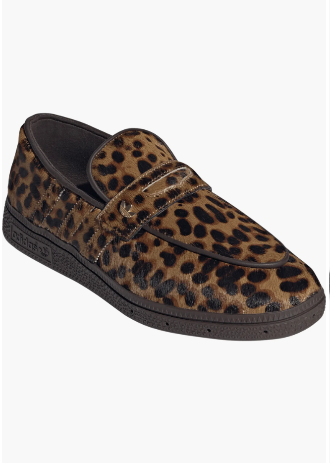 A pair of Adidas Handball Spezial Loafers featuring a textured leopard print upper and a dark brown gum sole—a trendy "Personality Piece" for a 2026 capsule wardrobe.