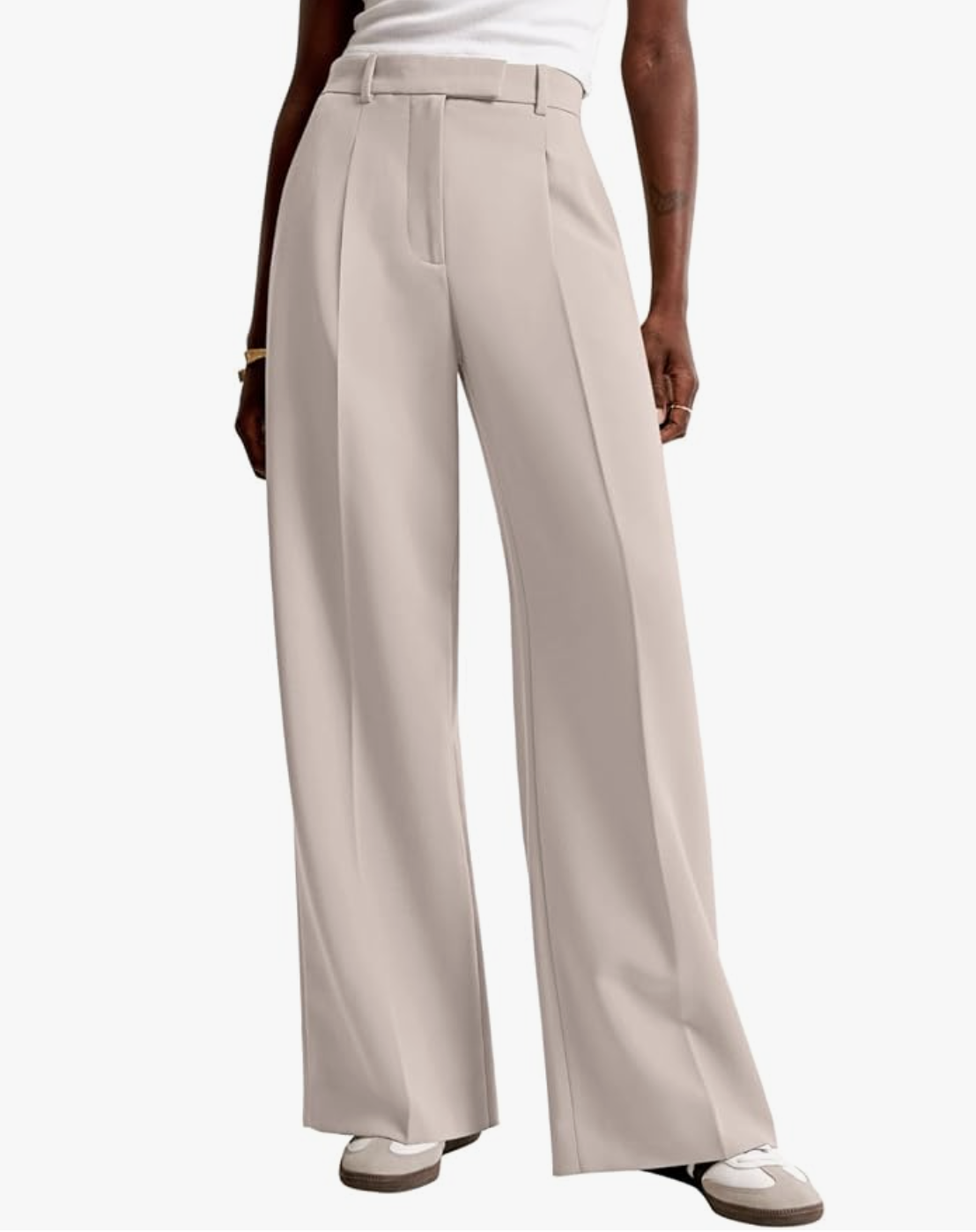 Professional work outfit featuring high-waisted wide-leg beige trousers and white sneakers for a minimalist business casual look.