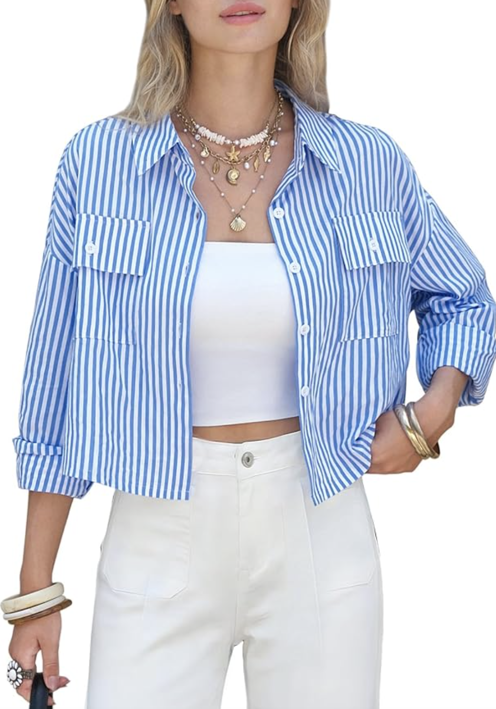 Woman wearing an EXLURA blue and white striped 100% cotton cropped button-down shirt with white high-waisted jeans, a stylish spring outfit for women over 60.