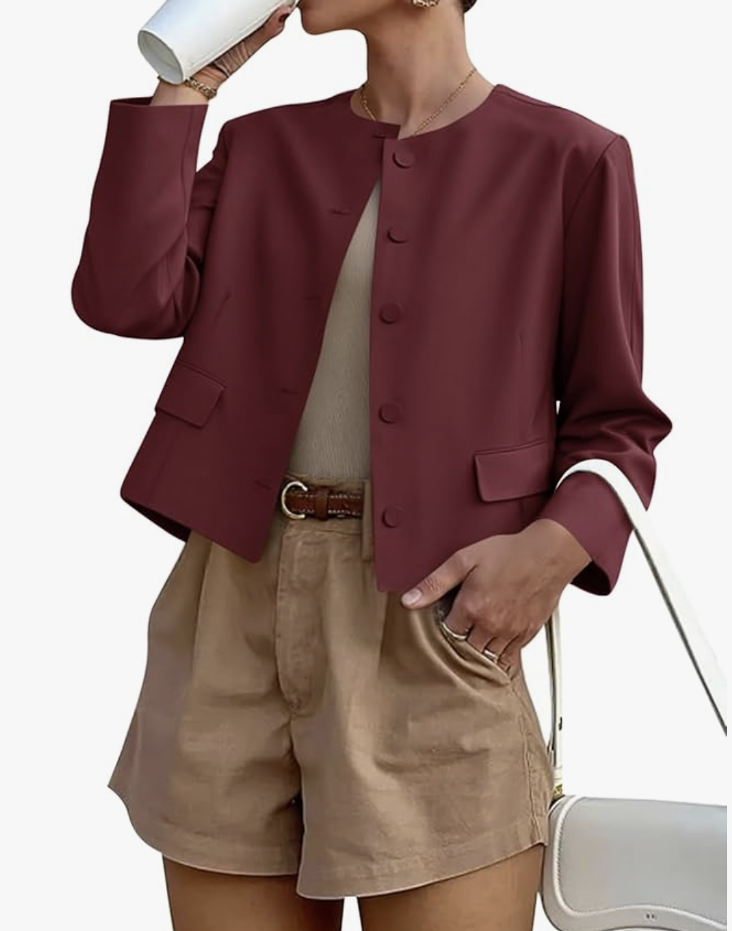 A studio product shot of a woman wearing a maroon Long Sleeve Blazer from Amazon, styled with high-waisted khaki pleated shorts and a brown belt.