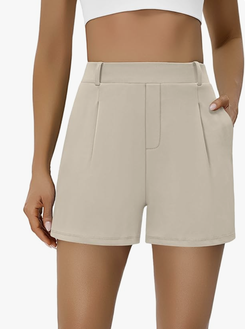 Woman wearing BMJL khaki pleated high-waisted shorts with a tailored front and pockets, a comfortable yet dressy summer outfit for women over 60.