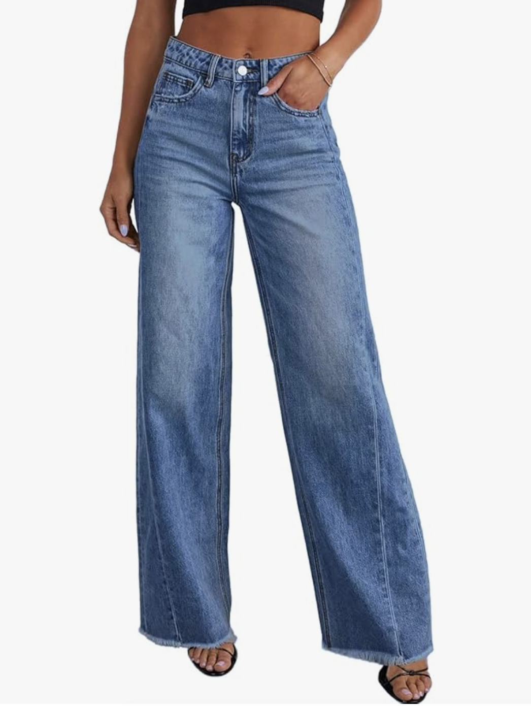 A woman wearing light wash Amazon Essentials High Stretch High-Rise Flare Jeans with a raw hem, styled with black strappy sandals. These affordable jeans offer a smoothing high-waist fit and a classic retro flare silhouette.