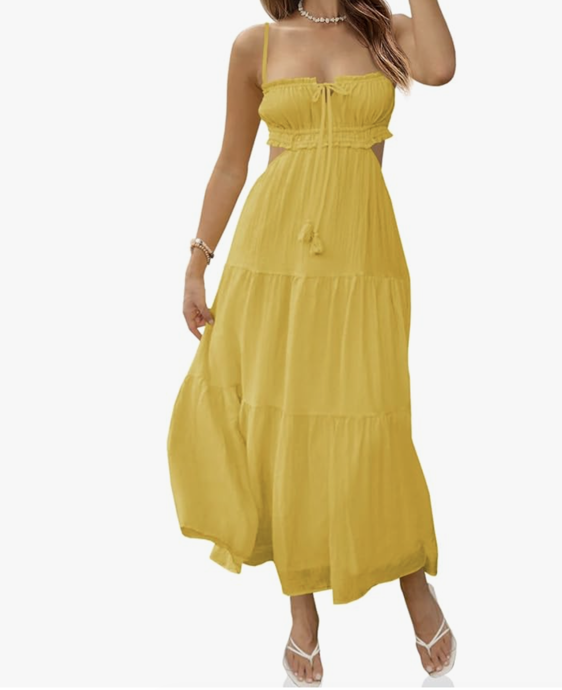 A woman wearing a vibrant yellow midi sundress with a tiered maxi skirt, a keyhole tie bodice, and a side cutout detail.