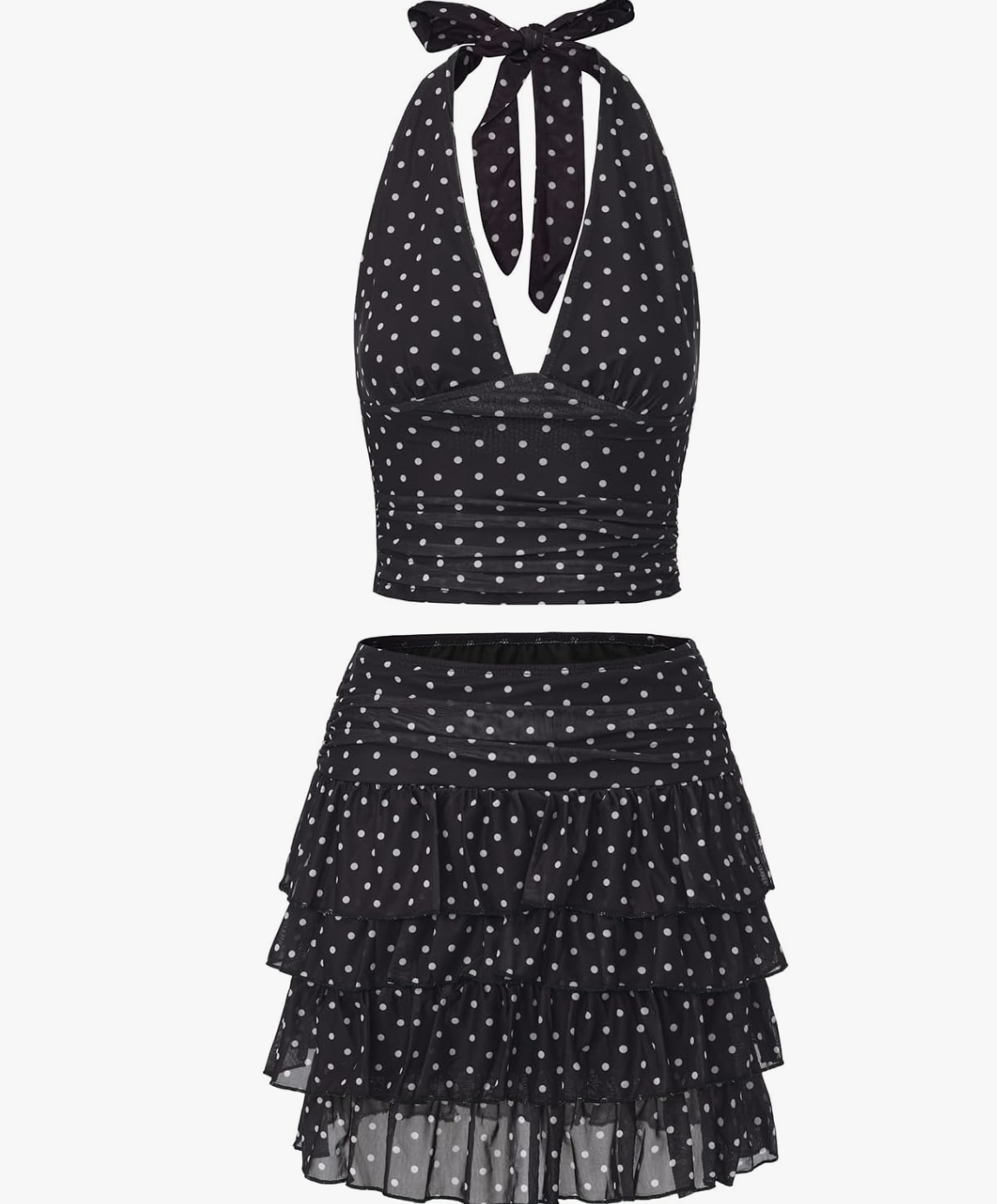 A two-piece matching set featuring a black halter-neck top with white polka dots and a matching tiered ruffle mini skirt with a smocked waistband.
