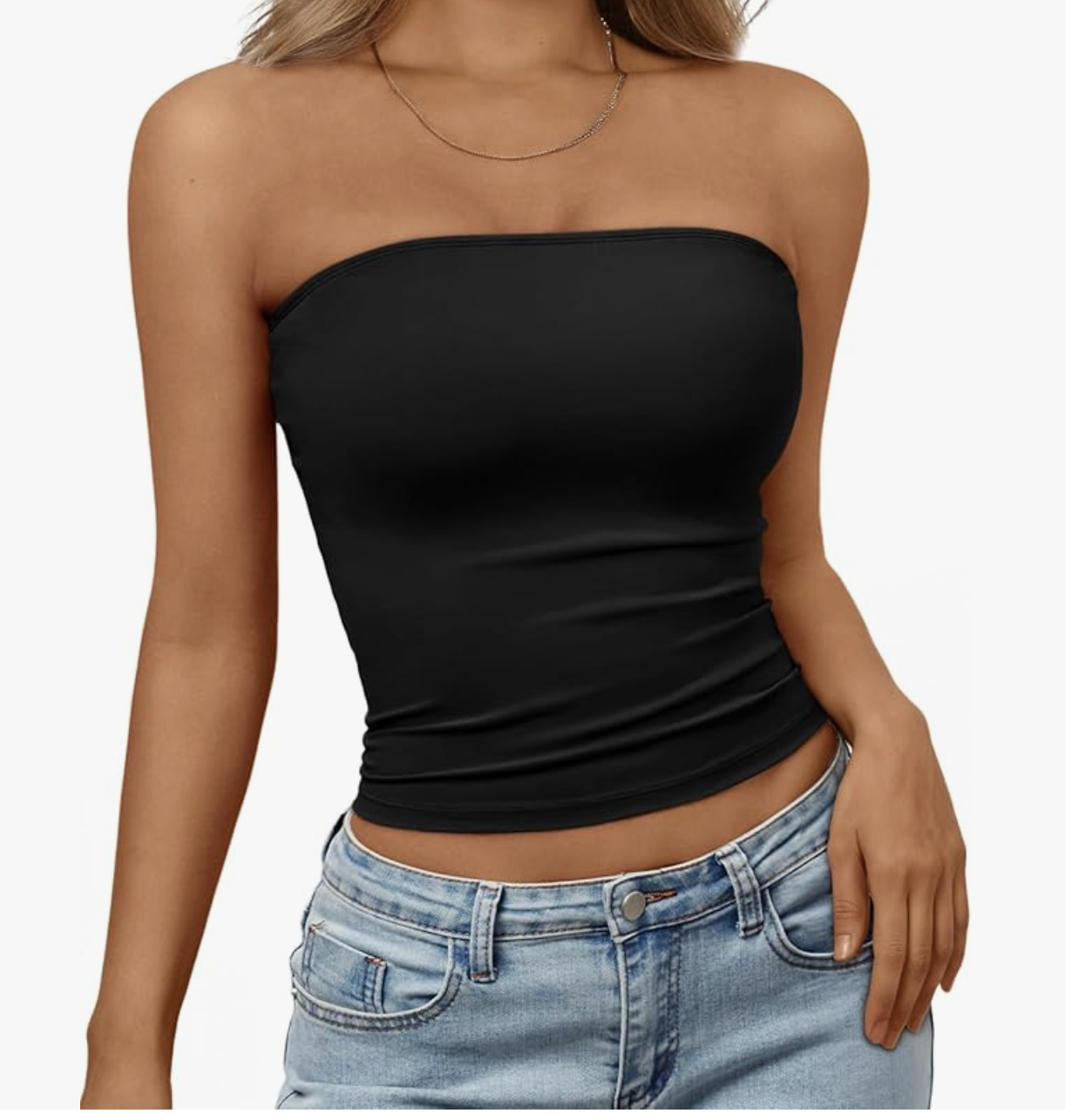 Close-up of a black strapless bandeau crop top paired with light-wash denim jeans.