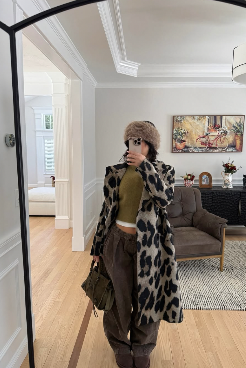 A pro stylist-inspired layering outfit featuring a white t-shirt layered under a leopard print cardigan with wide-leg trousers.