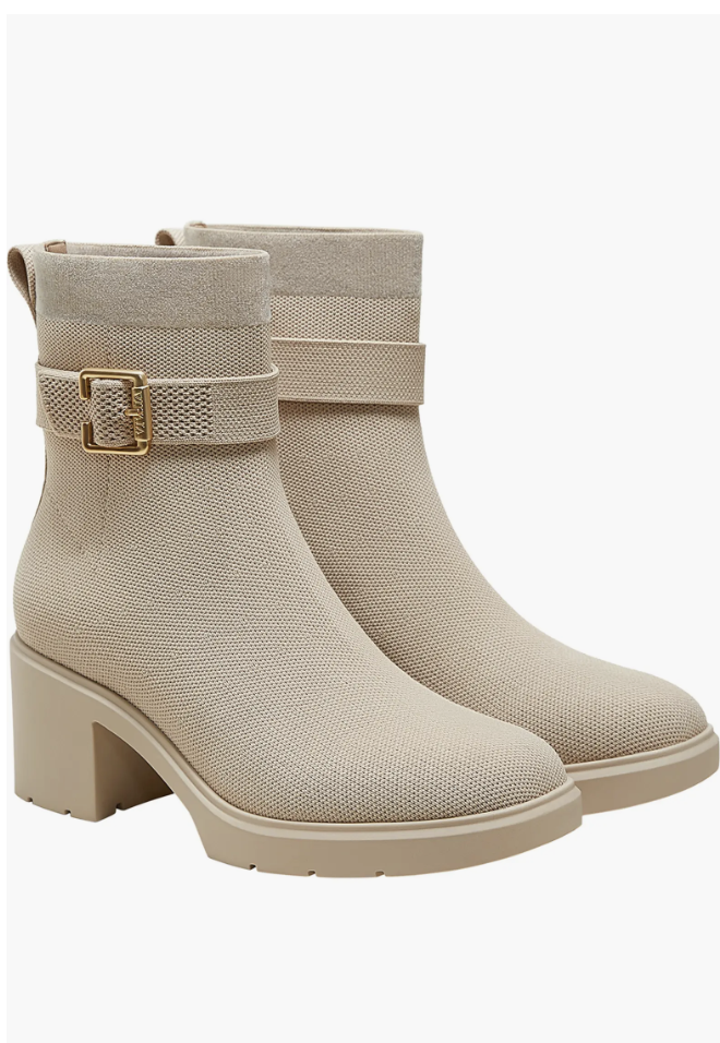 Pair of beige knit ankle boots with a gold buckle strap and a chunky block heel.
