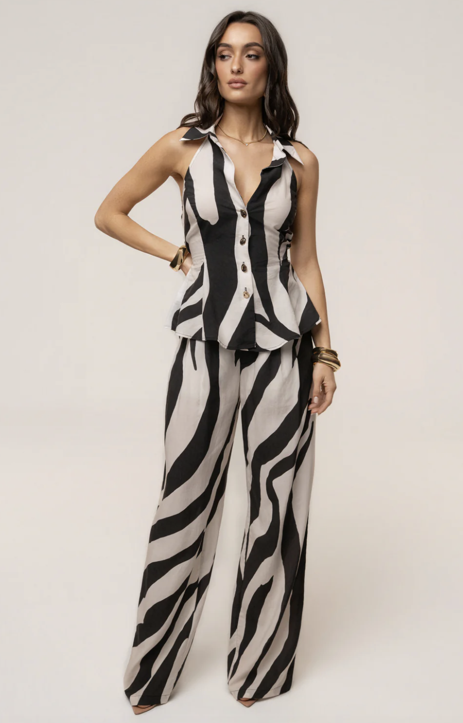 Fluid wide-leg trousers featuring a sophisticated neutral zebra print pattern with a relaxed silhouette.