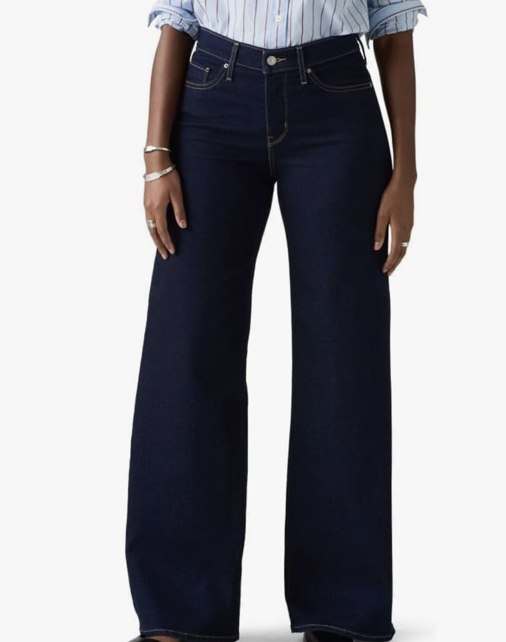 Model wearing Levi's 318 Shaping Wide-Leg Jeans in a dark wash, featuring a tummy-smoothing panel and a flared leg that balances a rectangle or athletic build.