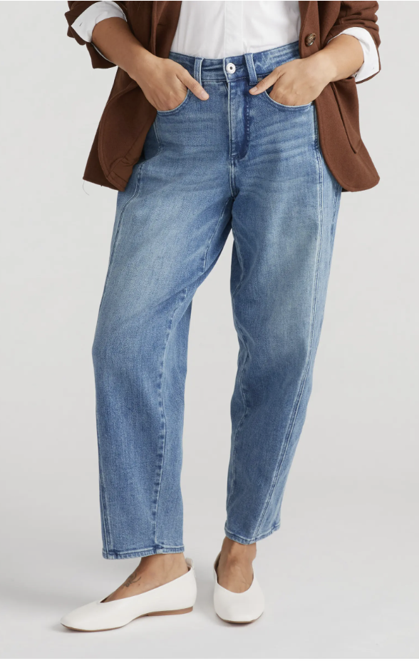 Woman wearing Universal Standard engineered straight leg jeans in Montana Blue showing a gap-free high-rise waistband.