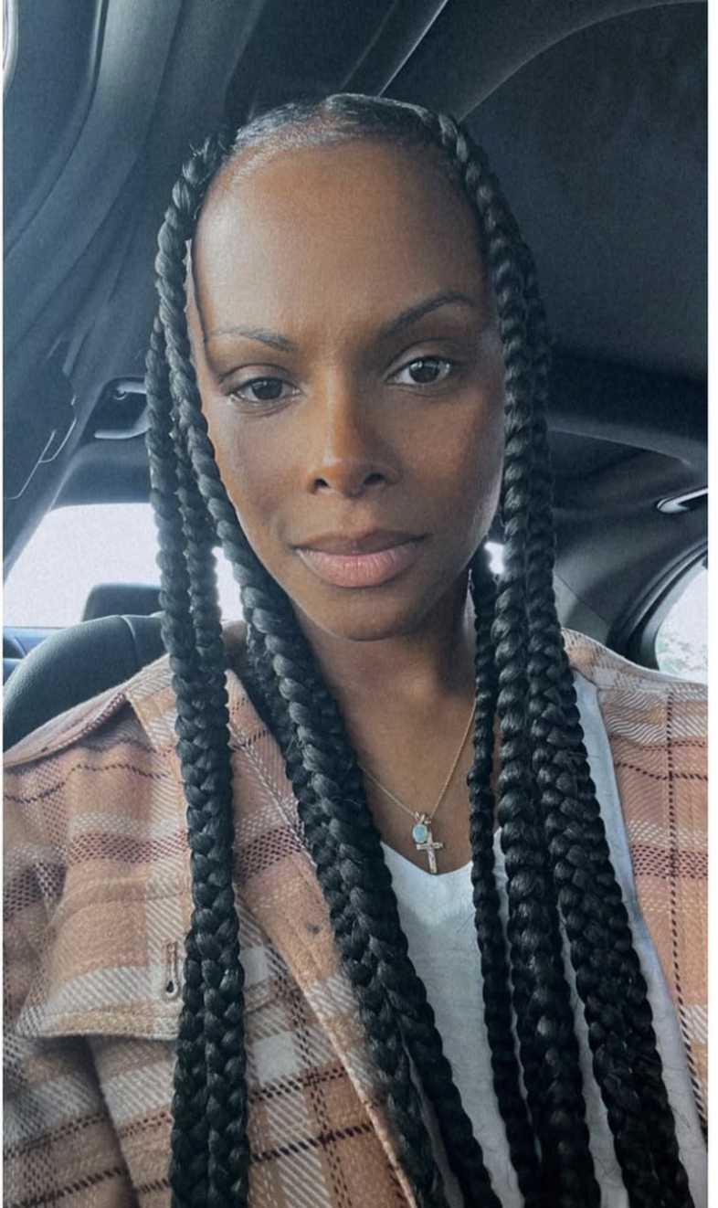 Tika Sumpter wearing jumbo box braids with a sleek middle part to complement an oval face shape.