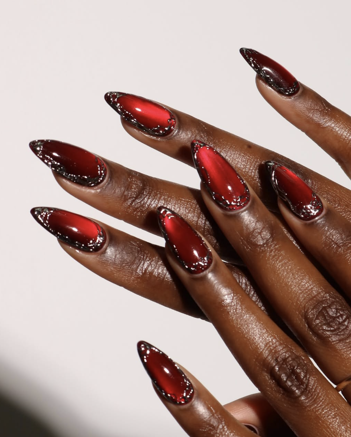 Red cat-eye shimmer nail polish design