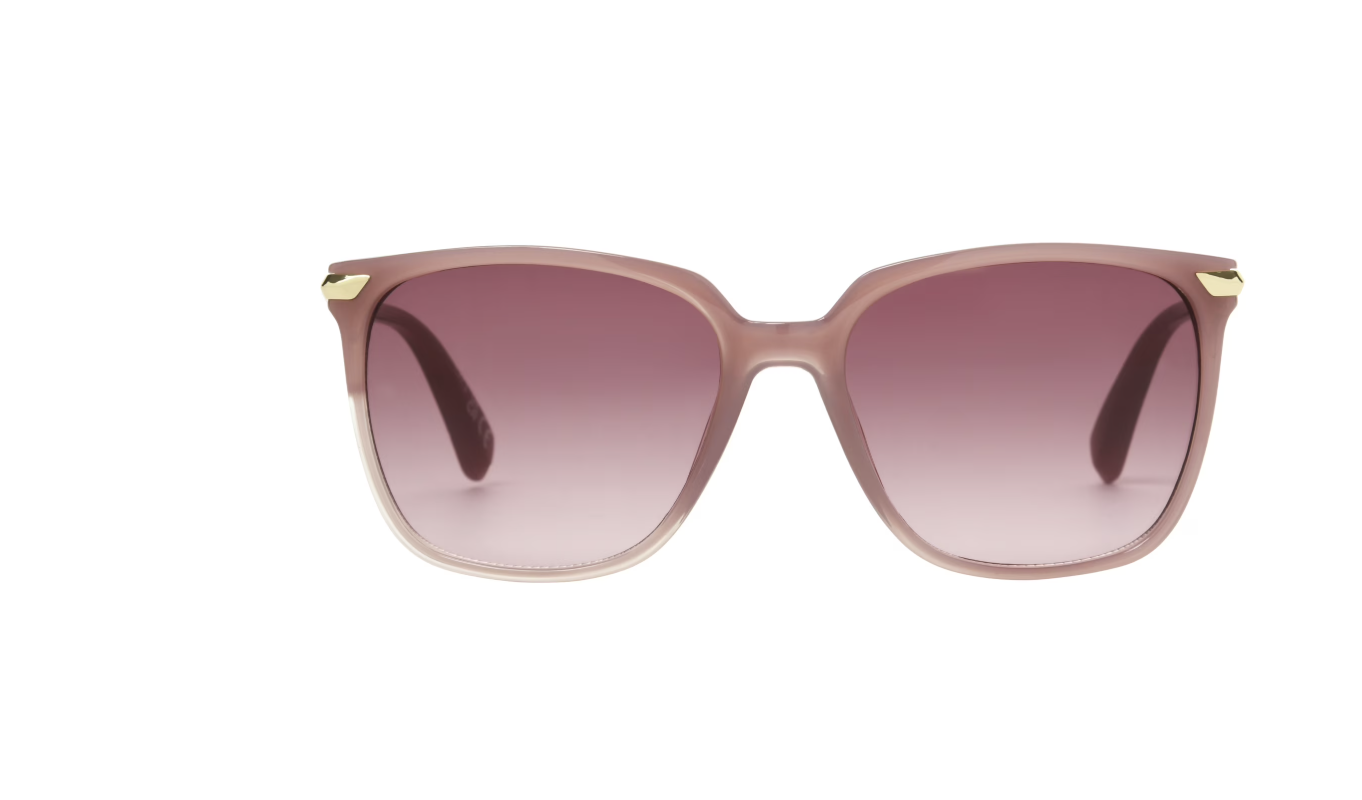 A product shot of trendy women's sunglasses featuring a translucent pinkish-brown square frame with dark gradient tinted lenses and subtle gold corner accents.