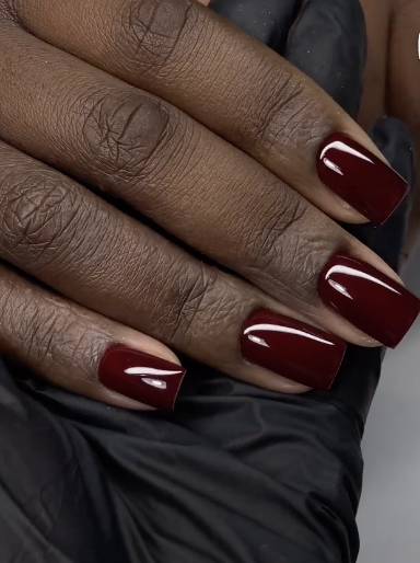 A deep black cherry Italian manicure on short squoval nails, featuring glossy dark wine polish painted with thin unpainted sidewalls to elongate the nail plate.