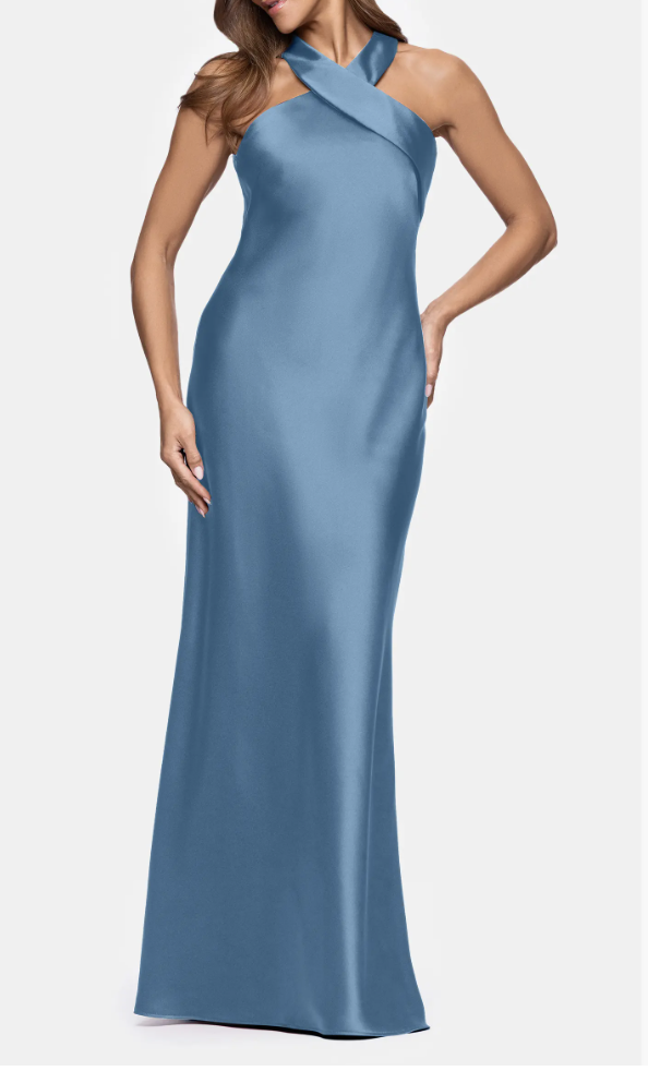 A woman wearing a floor-length slate blue satin gown featuring a criss-cross halter neckline and a sleek, flowing maxi skirt that creates a sophisticated column silhouette.