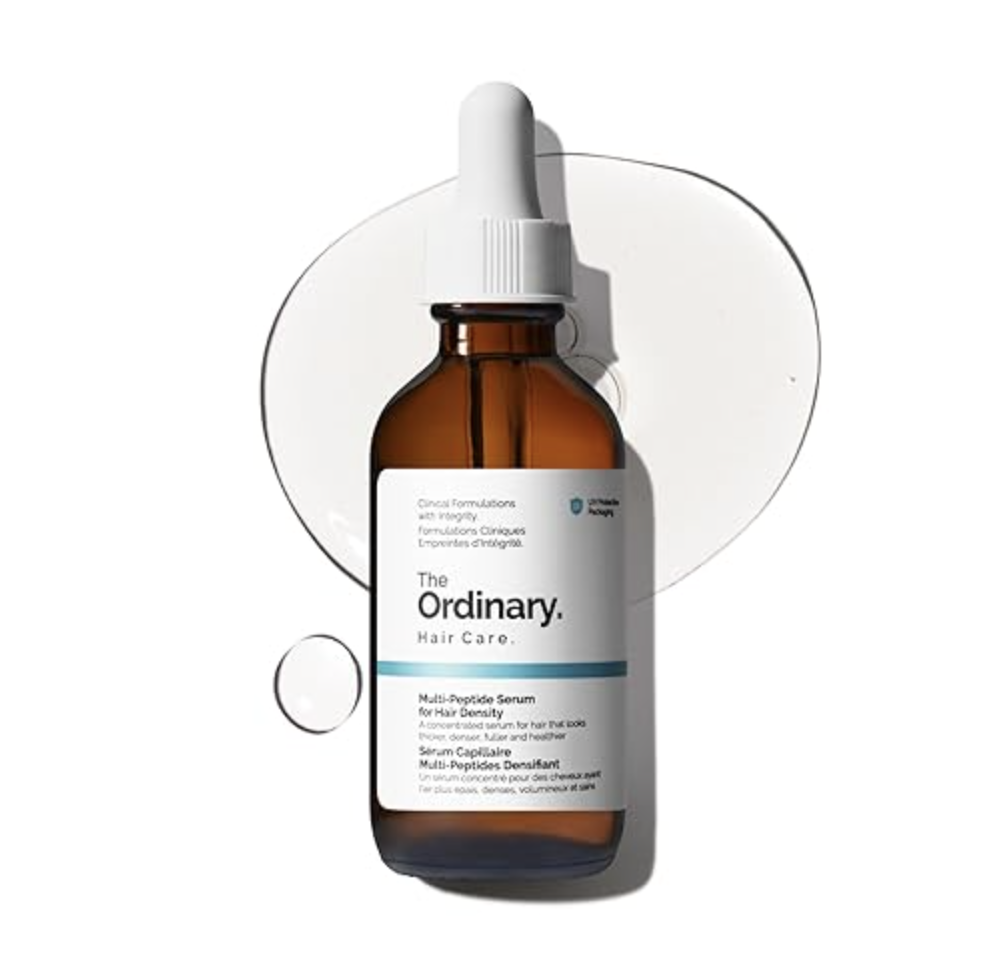 An amber glass dropper bottle of The Ordinary Multi-Peptide Serum for Hair Density with a white and grey label, featuring a minimalist design.
