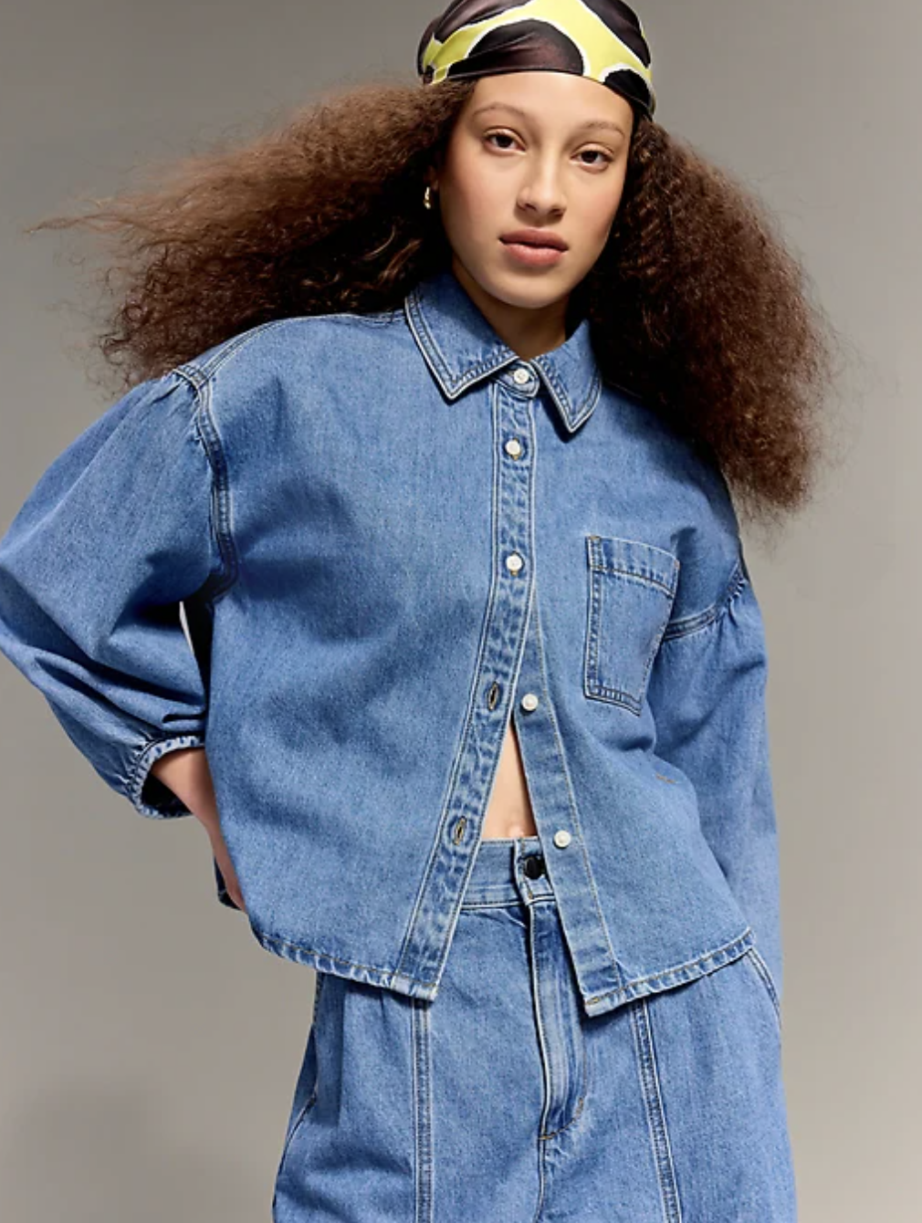 Model wearing the Old Navy x Christopher John Rogers oversized button-down jean shirt with voluminous sleeves and a pointed collar.