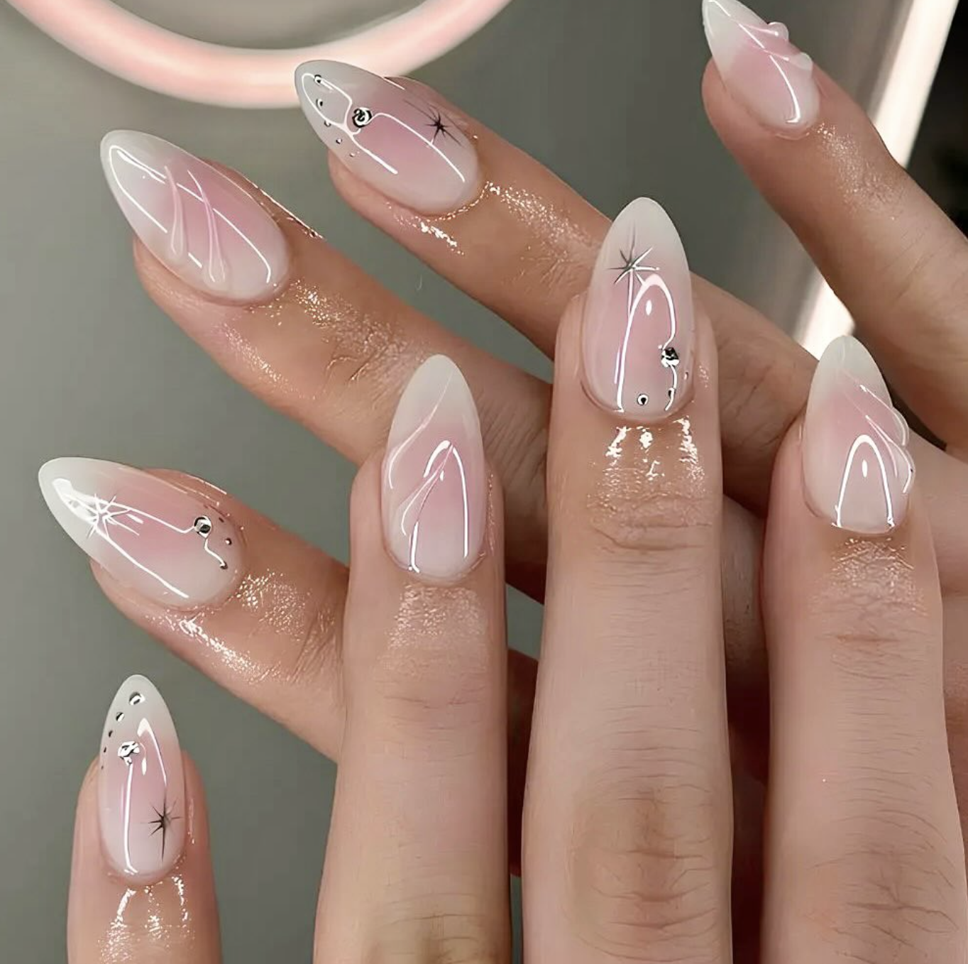 2026 nail trends: Decorative milky nails with star accents and gems for a whimsical, polished look.