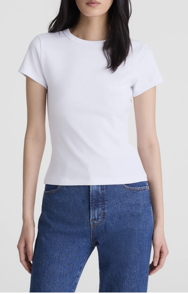 A woman wearing the Madewell 90s Crewneck Compact Cotton T-Shirt in white tucked into blue straight-leg jeans.