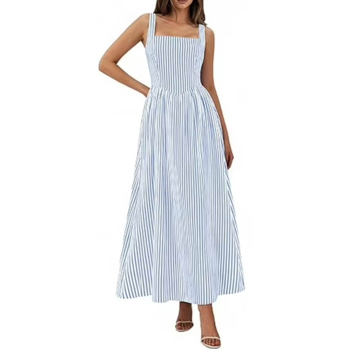 A full-length product shot of a light blue and white vertical striped halter midi dress with a structured drop-waist bodice, a flared A-line skirt, and delicate self-tie halter straps, styled with tan strappy sandals.