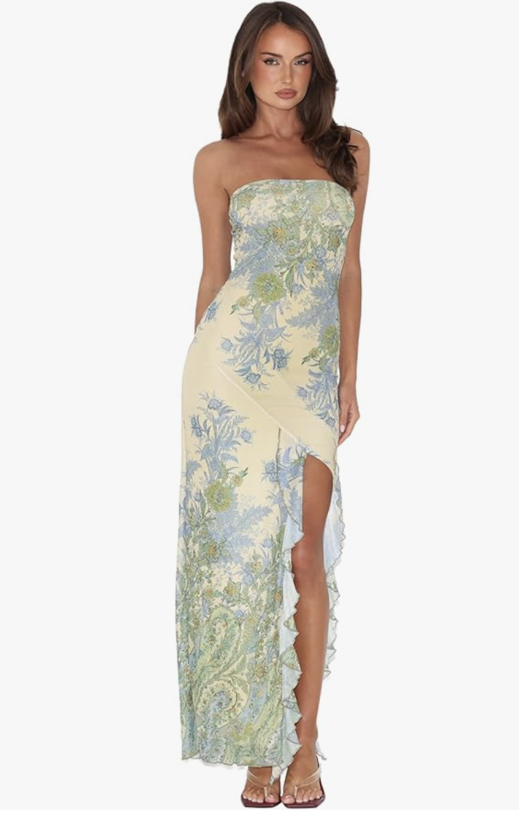 A woman wearing the Tiger Mist Theo Maxi Dress in a green floral paisley print, featuring a strapless neckline and a high thigh-slit.