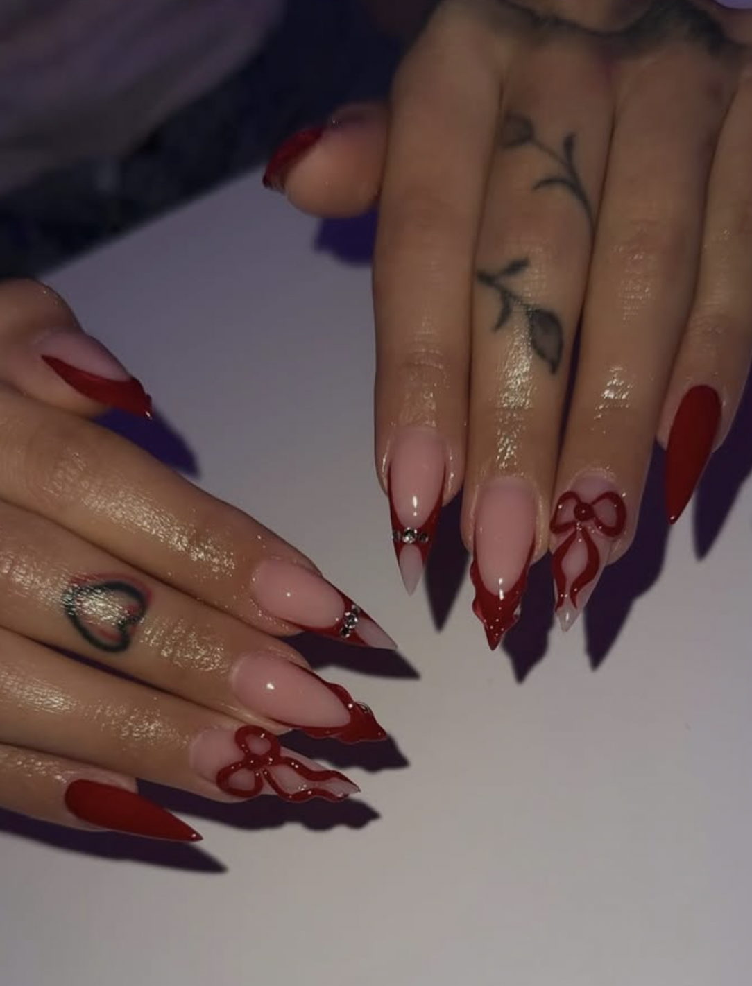 Deep velvet red Christmas manicure with a tonal bow accent
