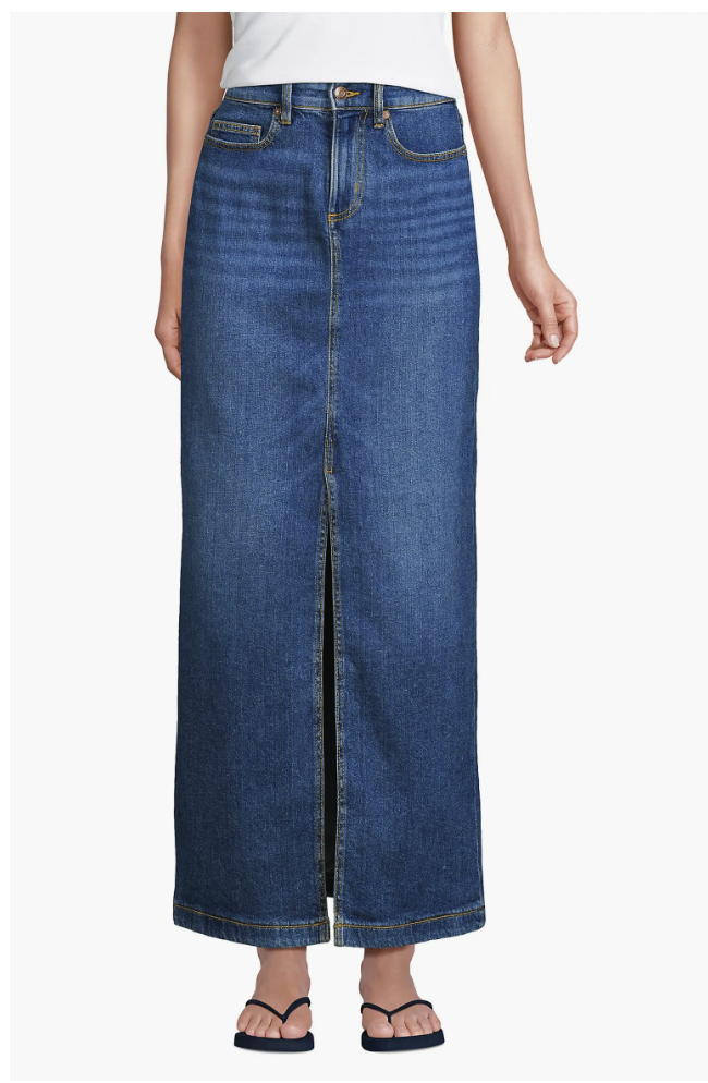 Close-up of a high-waisted dark wash denim maxi skirt featuring a prominent front slit and light fading details.