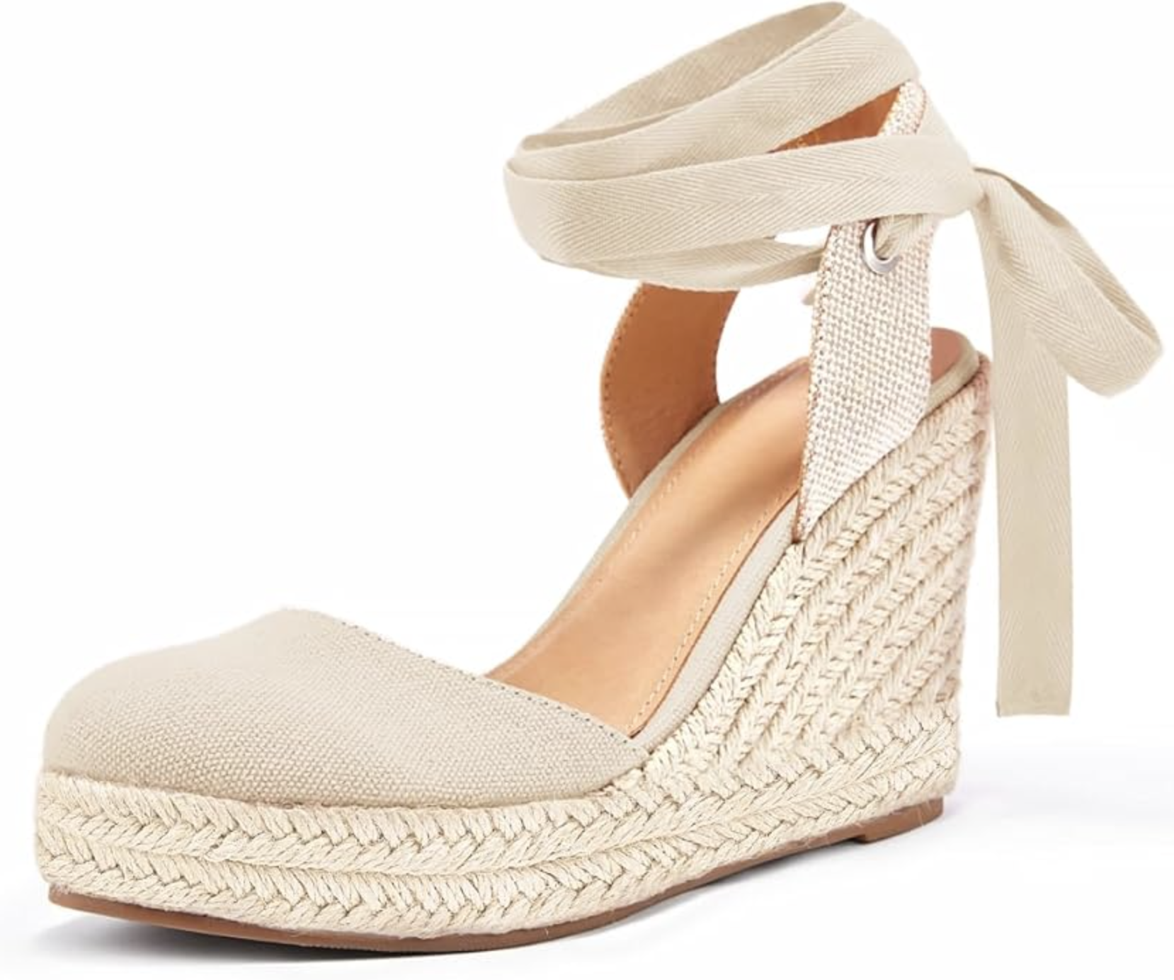 A pair of beige closed-toe espadrille wedge sandals with a woven jute platform and wrap-around ankle straps, styled as a comfortable summer footwear option.