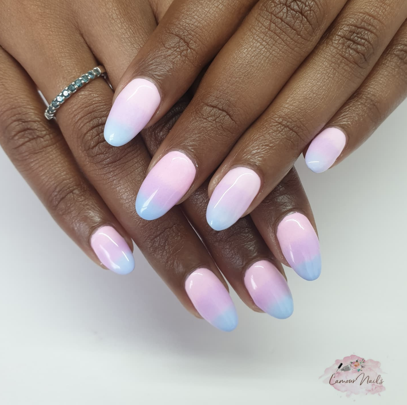 Medium oval-shaped nails featuring a soft, seamless pastel gradient shifting from a milky white base into shades of baby pink, lavender, and sky blue.