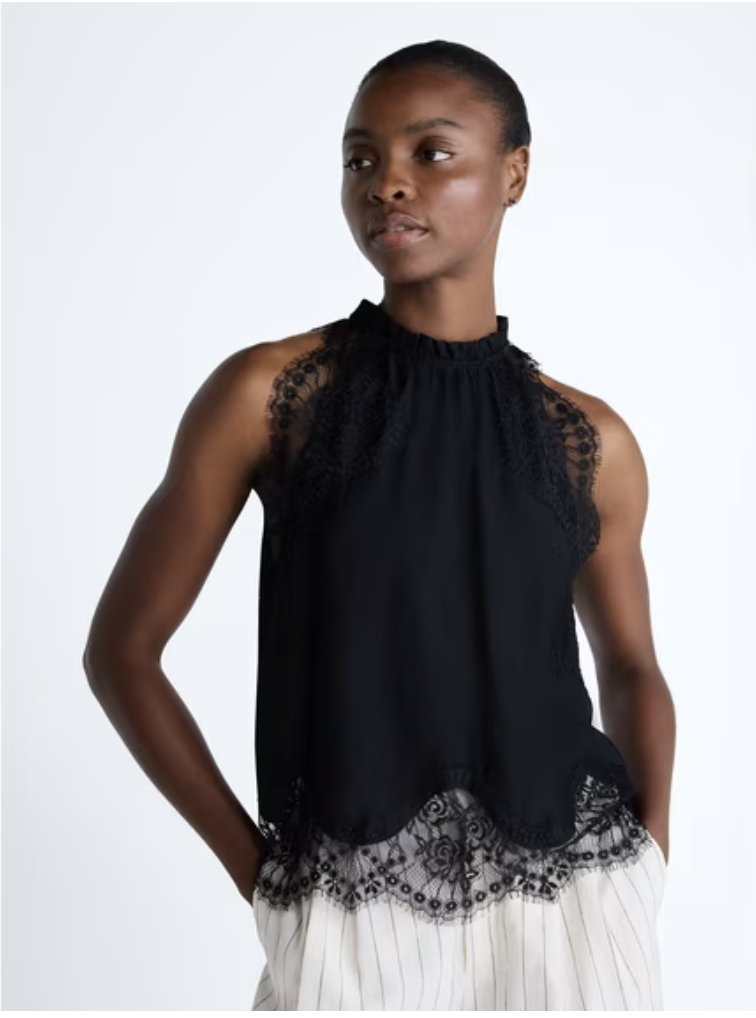 A feminine halter top featuring delicate lace trim detail along the neckline.
