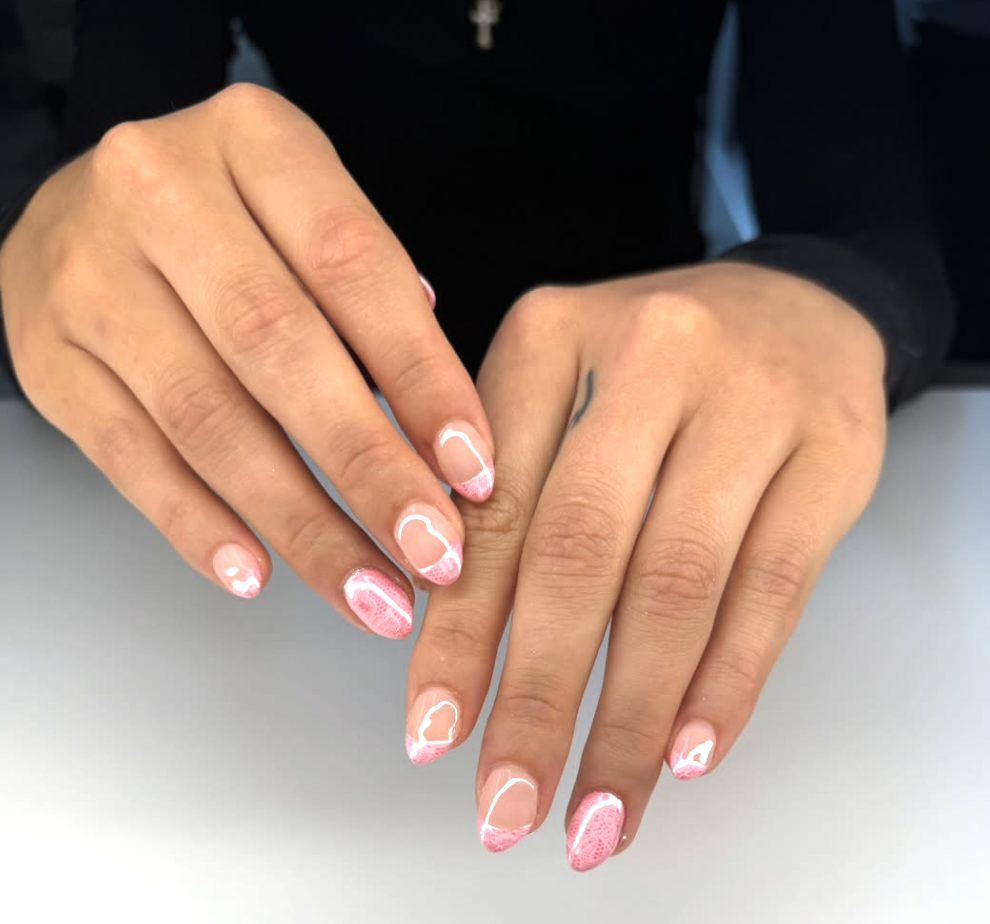 Long almond-shaped nails with a pink and white ombre base featuring white lace patterns and high-shine metallic silver chrome accents.
