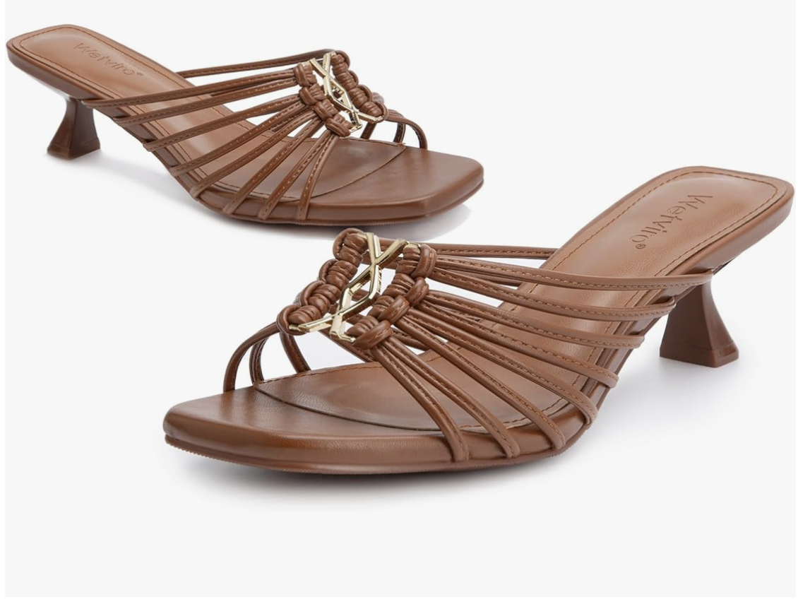A pair of chocolate brown strappy mule sandals with a square toe, thin kitten heel, and gold chain-link hardware on the center strap, shown on a transparent background.