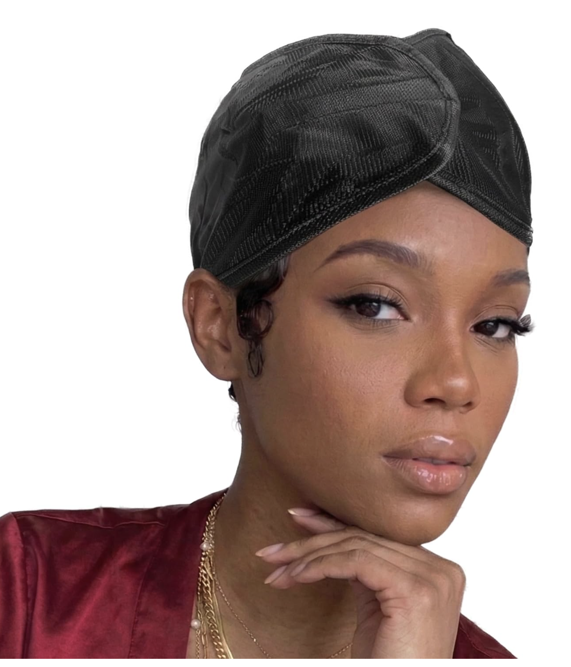 Woman wearing a black DONNA satin wrap cap with a burgundy satin top and gold necklaces.