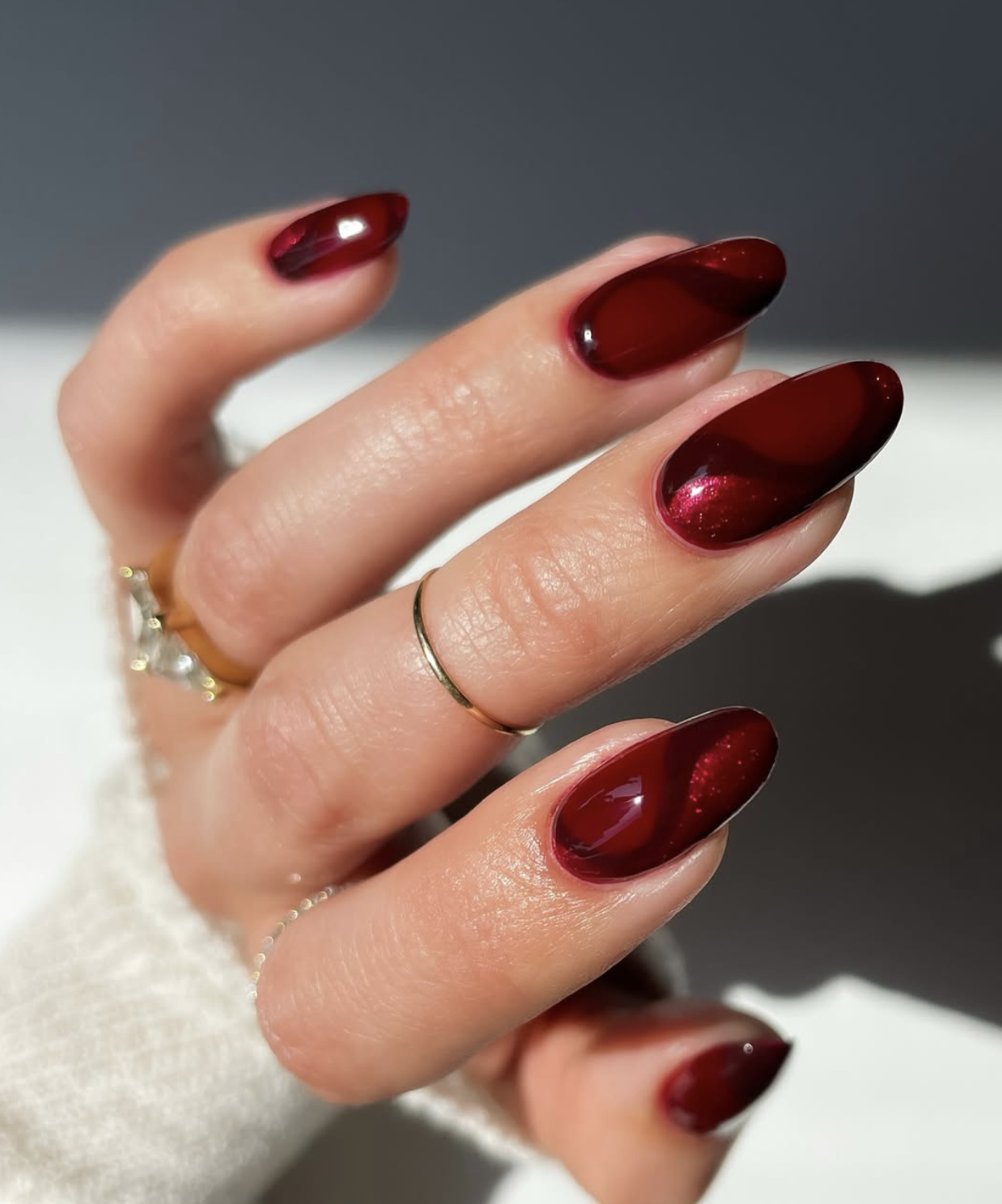 Deep red velvet Christmas nails with a magnetic cat-eye finish
