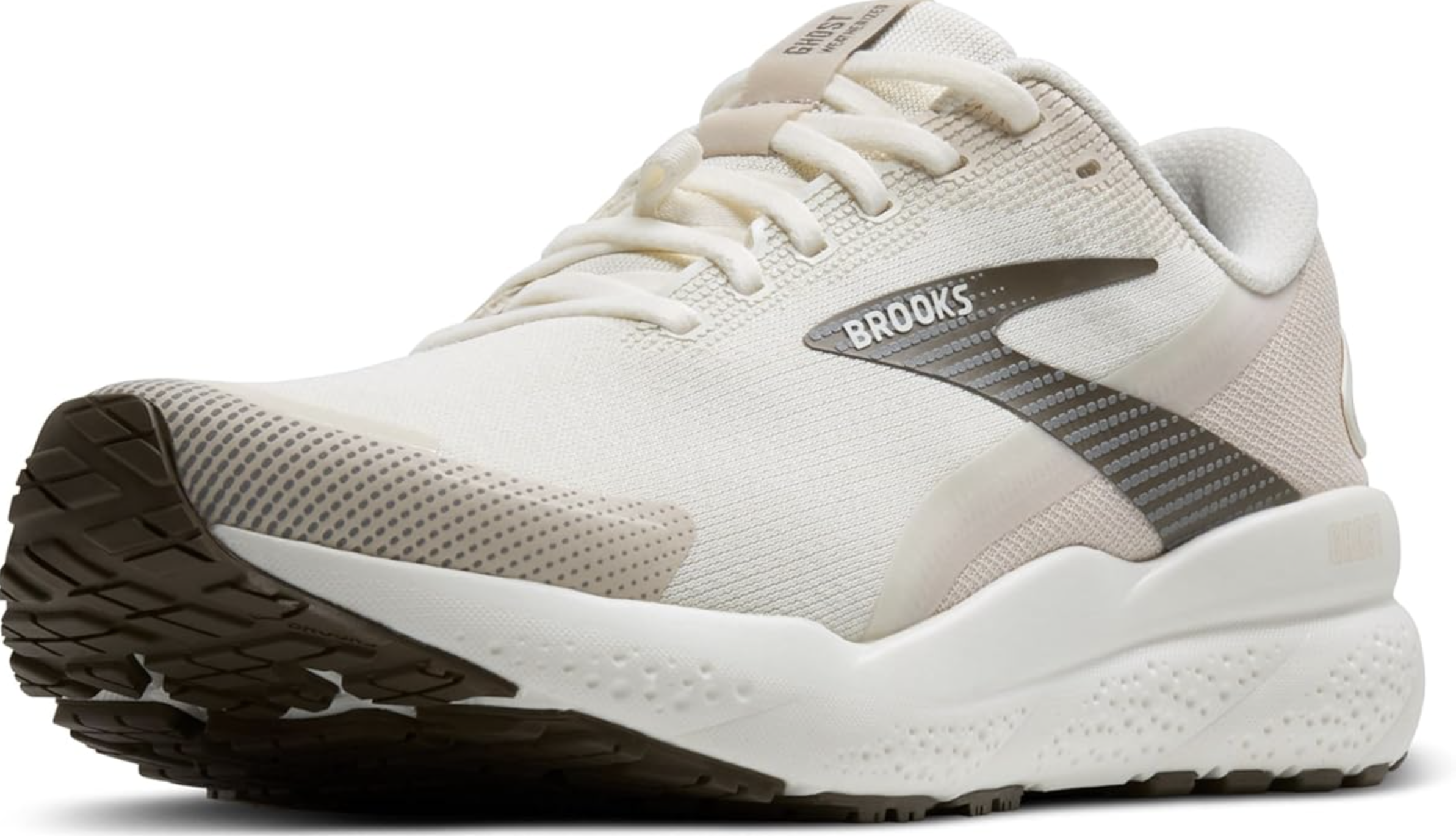 A side profile of the Brooks Ghost 16 in a white and grey colorway, showing the neutral cushioning and plush midsole designed for long-distance walking and travel.