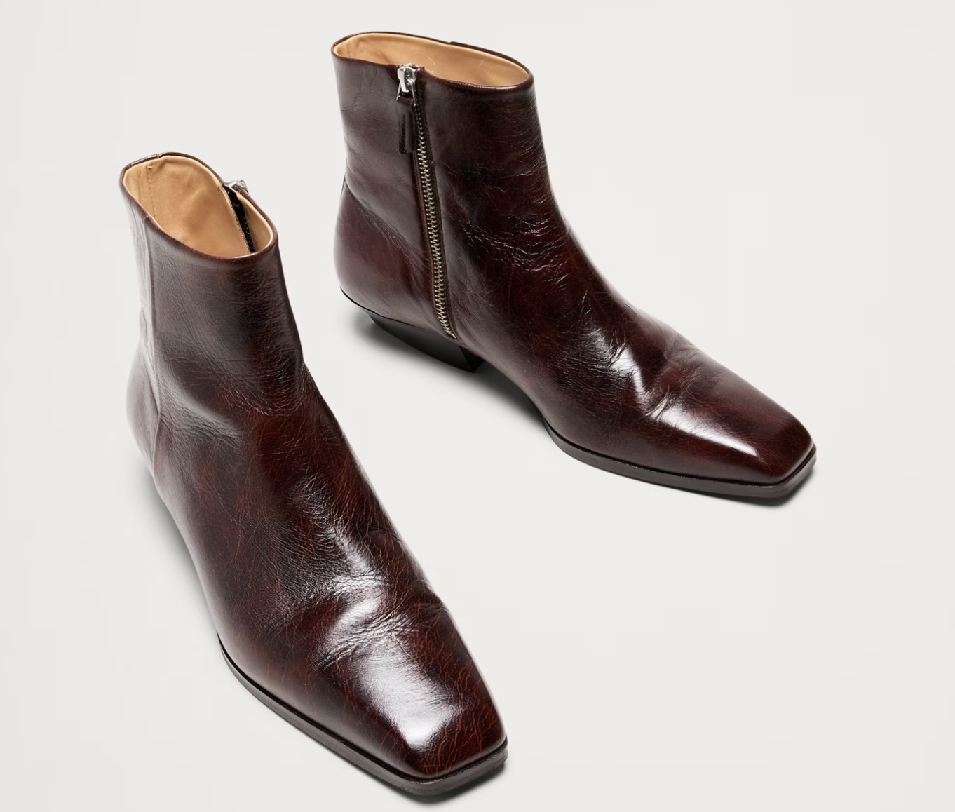 A pair of Banana Republic dark cherry leather ankle boots with a square toe and side zipper.