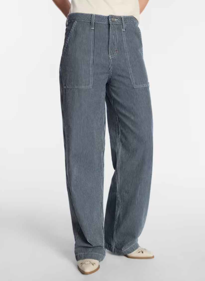 Slouchy mid-rise loose carpenter jeans with utility pockets in a mid-wash finish.