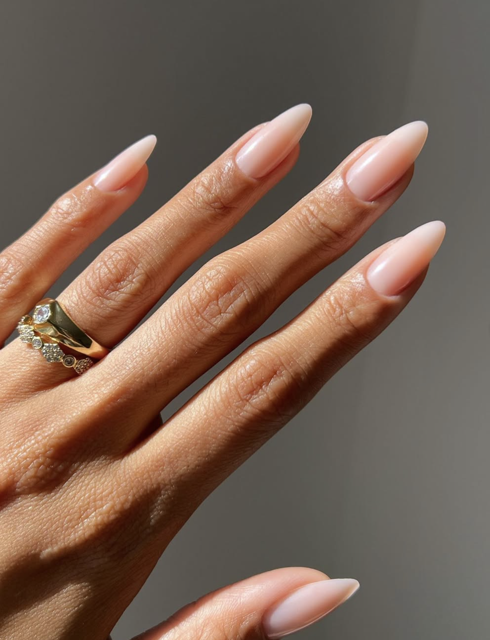 Long, elegant coffin-shaped nails featuring a flawless, semi-sheer milky white manicure with a clean, high-gloss finish.
