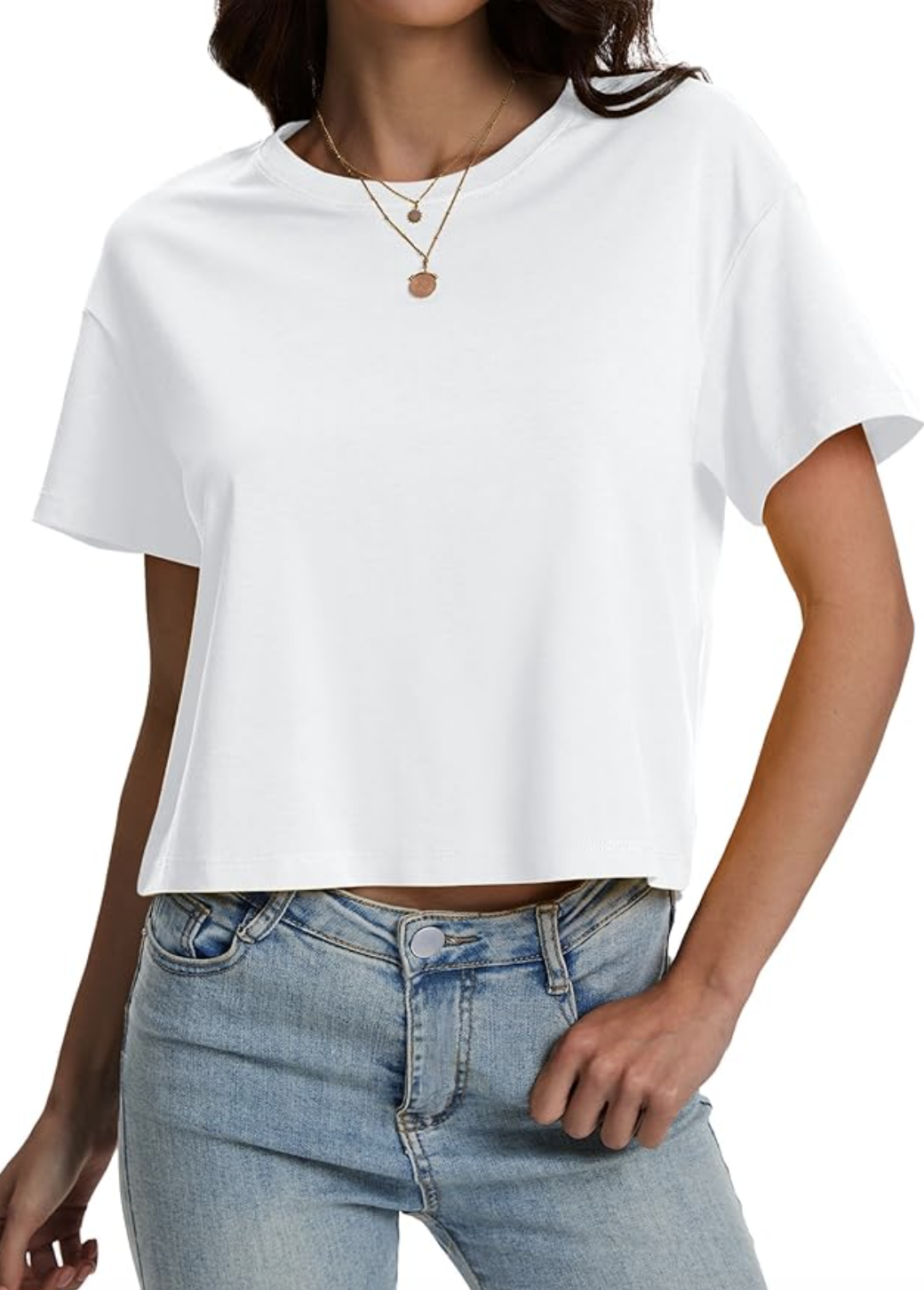 A close-up of a woman wearing light-wash, high-waisted relaxed-fit denim jeans with a classic silver button closure and belt loops.