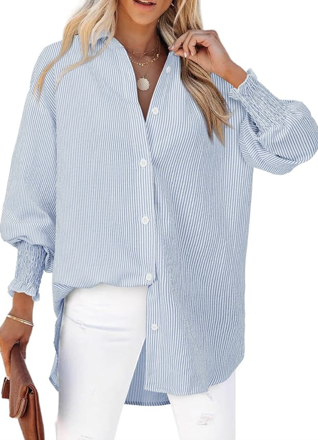Close-up of an oversized blue and white striped button-down shirt paired with white jeans.