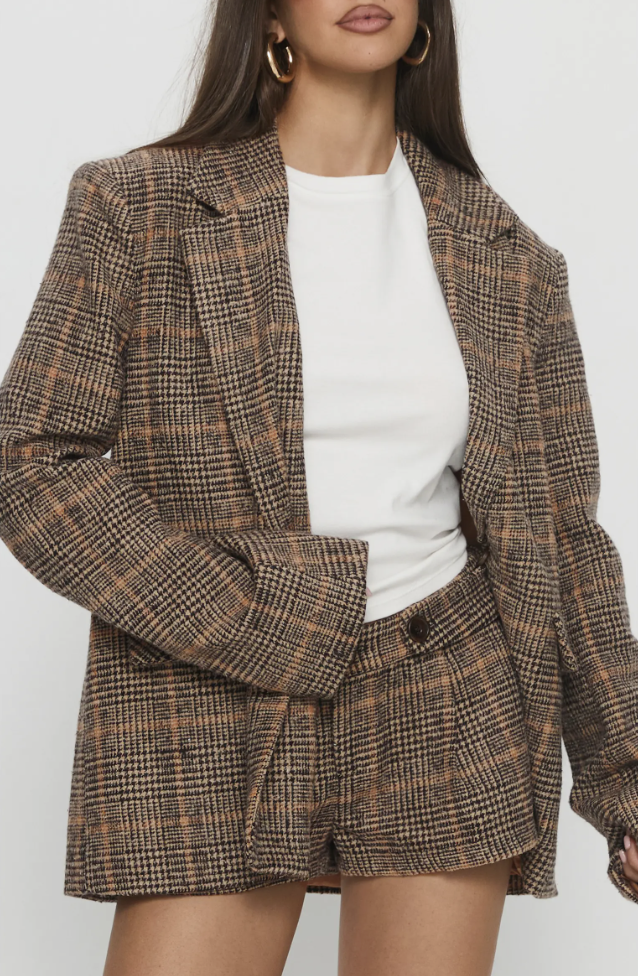 Brown plaid blazer styled over a white t-shirt.