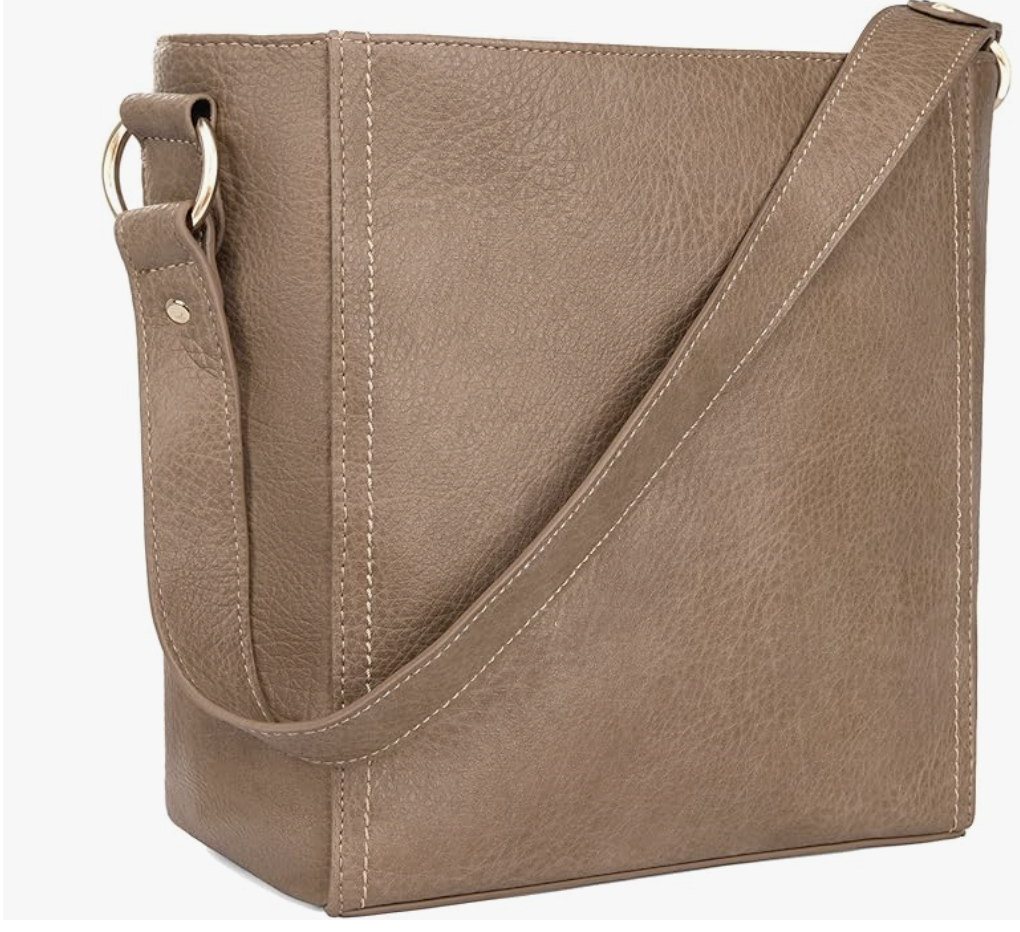 A slouchy taupe vegan leather hobo shoulder bag with a thick matching strap on a transparent background.