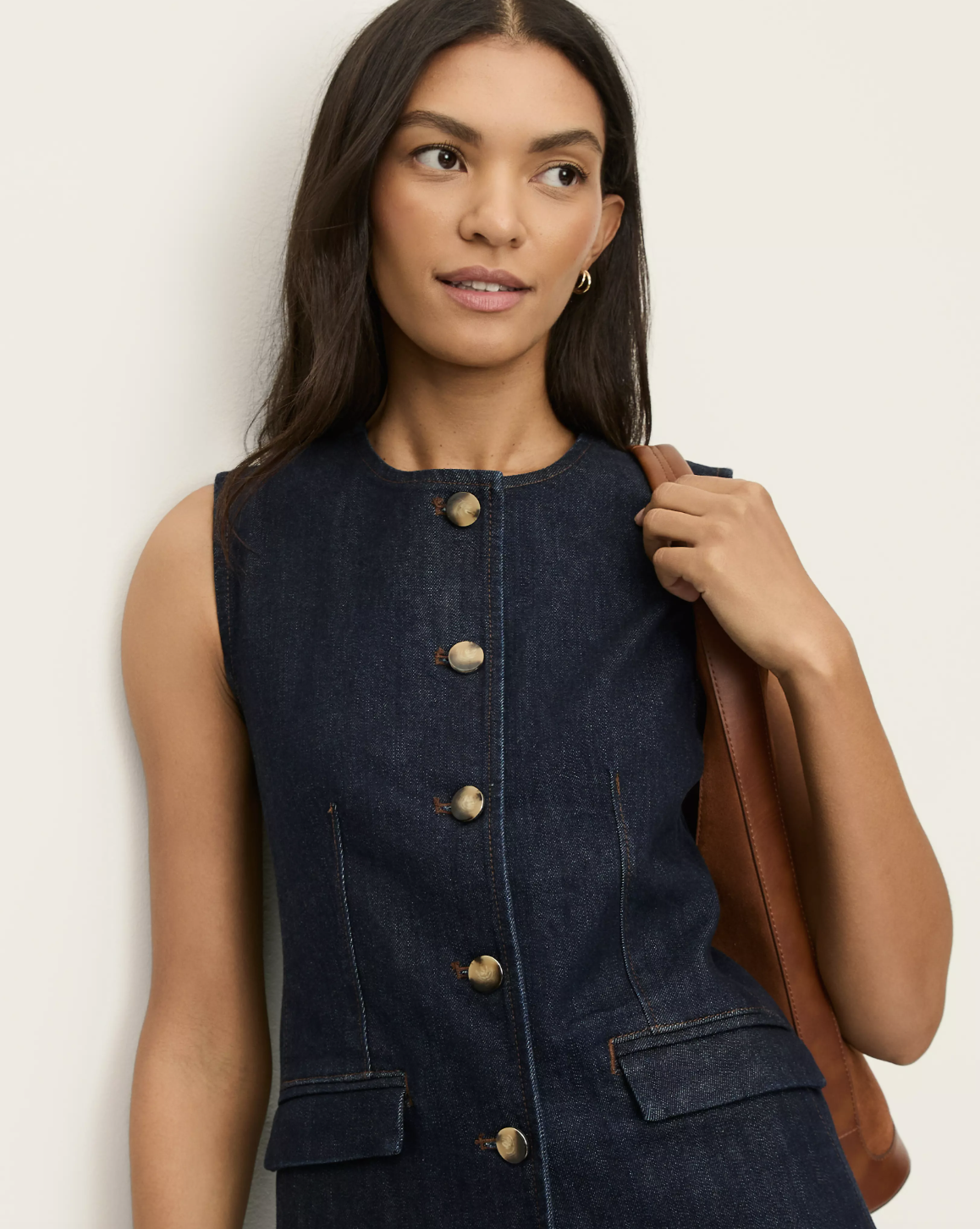 Professional stylist's pick for the Ann Taylor Petite Refined Denim Vest in a dark indigo wash, featuring gold-tone buttons and a structured sleeveless silhouette.
